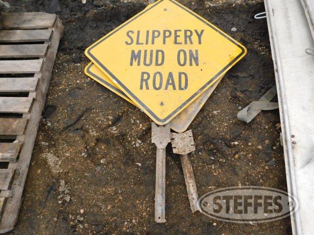 (2) "Slippery Mud on Road" signs